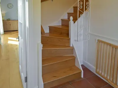 a staircase in a home with wood steps at Granary Cottage in Bentley