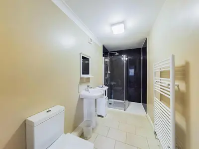 a bathroom with a toilet and a sink and a shower at The Cambridgeshire in Newmarket