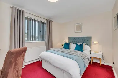 a bedroom with a large bed and a window at The Cambridgeshire in Newmarket