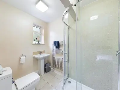 a bathroom with a shower and a toilet and a sink at The Cambridgeshire in Newmarket