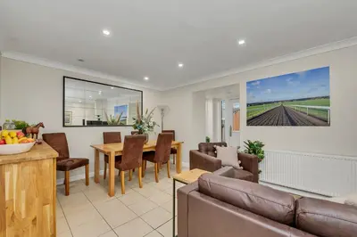 a living room with a couch and a table at The Cambridgeshire in Newmarket