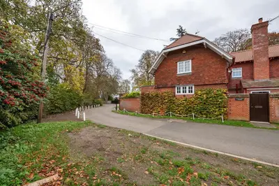 a brick house with a road in front of it at The Cambridgeshire in Newmarket