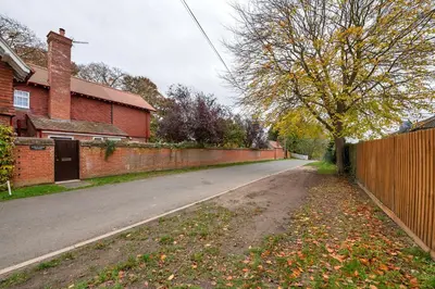 an empty street in a house with a fence at The Cambridgeshire in Newmarket
