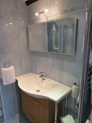 a bathroom with a sink and a mirror at The Greyhound - Historic former Inn in Glemsford