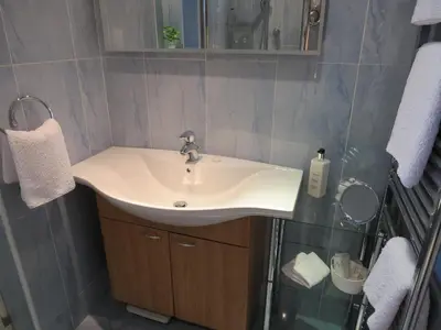 a bathroom with a sink and a mirror at The Greyhound - Historic former Inn in Glemsford