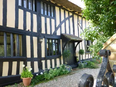 a black and white building with plants in front of it at The Greyhound - Historic former Inn in Glemsford