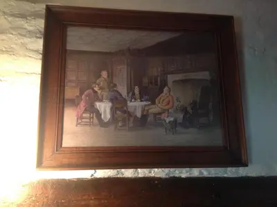 a painting of people sitting at a table at The Greyhound - Historic former Inn in Glemsford