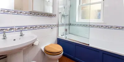 a bathroom with a toilet and a sink at Waterfront Cottage in Aldeburgh