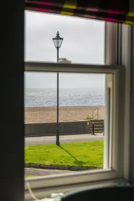 a view of the beach from a window at Waterfront Cottage in Aldeburgh