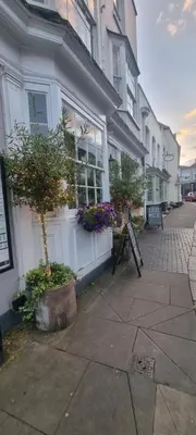 a building with flowers and plants in front of it at White Horse in Maldon
