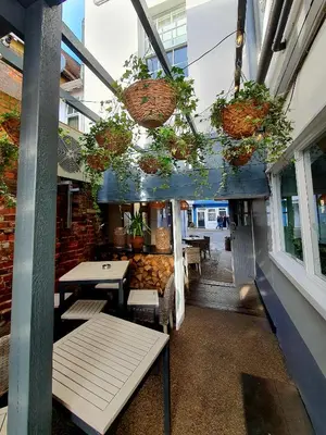 a room with tables and potted plants in a building at White Horse in Maldon