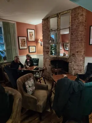 two people sitting at a table in a living room at White Horse in Maldon