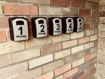 a brick wall with numbered clocks on a brick wall at Alder Lodge in Cambridge