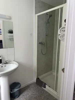 a bathroom with a shower and a sink at Alder Lodge in Cambridge