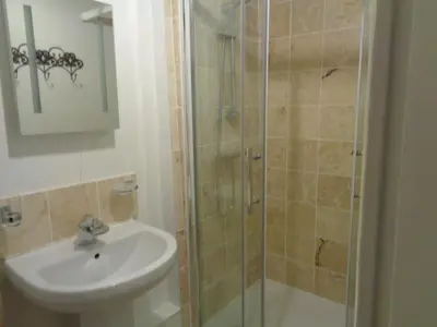 a bathroom with a shower and a sink at Minsmere Cottage in Yoxford