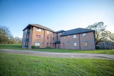 a large brick building with a grass field in front at University of Essex - Colchester Campus in Colchester