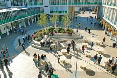 a group of people walking around a courtyard in a building at University of Essex - Colchester Campus in Colchester