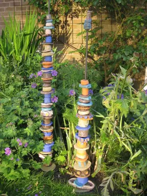a group of four colorful bird baths in a garden at Folly Studio Bed and Breakfast in Bungay