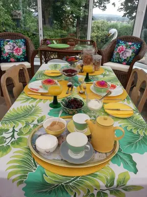 a table with a plate of food on it at Folly Studio Bed and Breakfast in Bungay