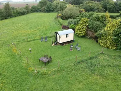 an aerial view of a small house in a field at Bells Meadow Shepherds Hut in Kings Lynn