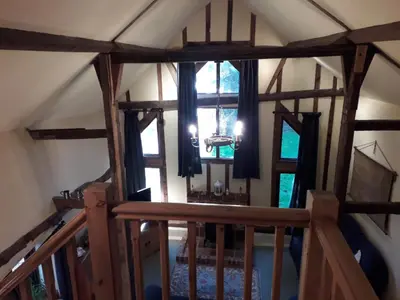an attic view of a room with windows at Granary Cottage in Hardwick