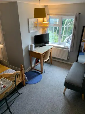 a room with a desk with a computer on it at The Holly Tree in Cambridge