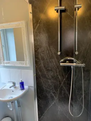 a bathroom with a sink and a shower at The Holly Tree in Cambridge