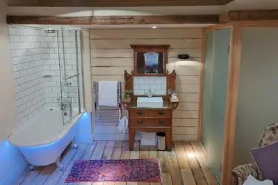 a bathroom with a tub and a sink and a bath tub at The Cross Keys in Saffron Walden