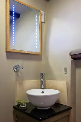 a bathroom with a sink and a mirror at The Cross Keys in Saffron Walden