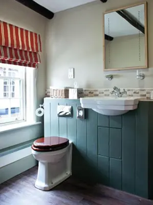 a bathroom with a toilet and a sink at The Cross Keys in Saffron Walden