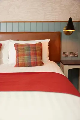a bedroom with a large bed with a red blanket at Feathers by Chef & Brewer Collection in Wadesmill