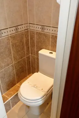 a bathroom with a white toilet in a shower at Aylesbray Lodge in Cambridge