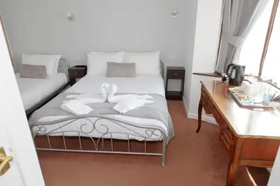a bedroom with a bed with two swans on it at Aylesbray Lodge in Cambridge