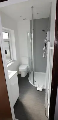 a white bathroom with a shower and a toilet at Aylesbray Lodge in Cambridge