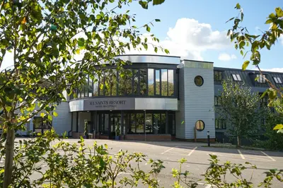 a building with a sign on the front of it at All Saints Resort in Bury Saint Edmunds