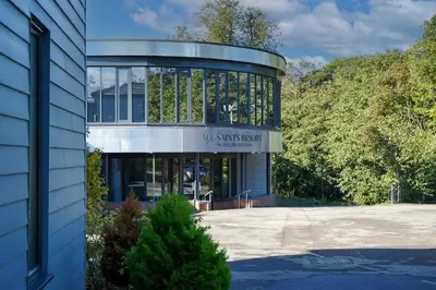 a building with a sign that reads milkskin act at All Saints Resort in Bury Saint Edmunds