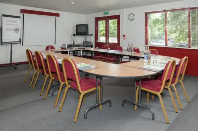 a conference room with a large table and chairs at Campanile Hotel - Basildon - East of London in Basildon