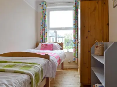 a small bedroom with a bed and a window at Sea Folly in Brightlingsea