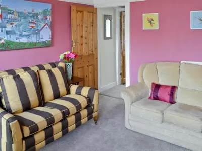 a living room with two chairs and a couch at Sea Folly in Brightlingsea