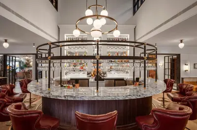 a bar in a hotel lobby with chairs at Clayton Hotel Cambridge in Cambridge