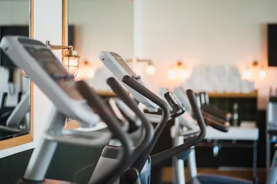 a row of gym chairs in front of a mirror at Clayton Hotel Cambridge in Cambridge