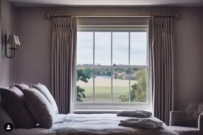 a bedroom with a bed and a large window at Marquis Suffolk in Ipswich