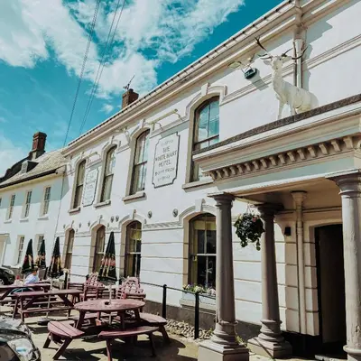 a building with a statue of a deer on the side of it at The White Hart Hotel in Hingham