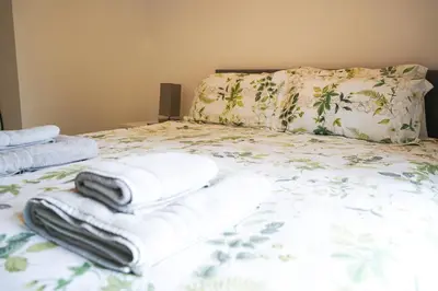 a bedroom with a bed with towels on it at Mersea Island Vineyard in East Mersea