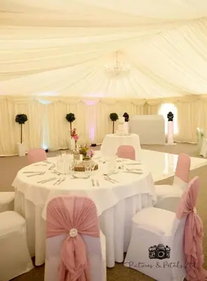 a white tent with a table and chairs in a room at Rettendon Lodge in Battlesbridge