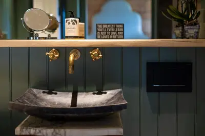 a counter with a bronze sink on a shelf at Cambridge Country Cottages in Cambridge