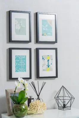 a group of framed pictures on a wall at Wherstead House in Ipswich