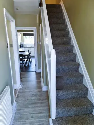a stairway leading to a dining room and kitchen at Wherstead House in Ipswich