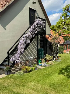 a purple wreath on the stairs of a house at Maltings Loft in Hepworth