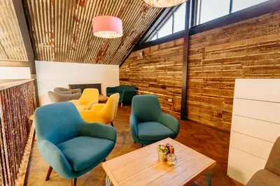 a waiting room with chairs and a table at Creeksea Place Barns in Burnham on Crouch